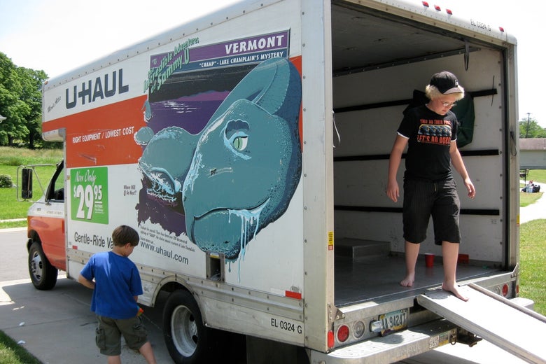 A woman and a boy in a moving van.